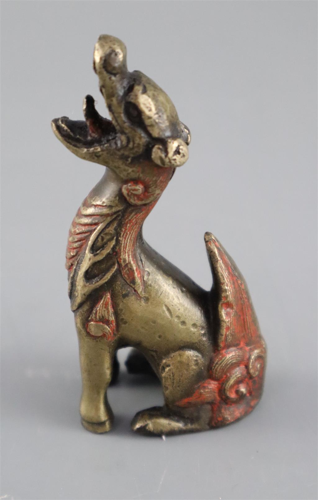 A Chinese bronze qilin scroll weight, 17th century, 8cm high